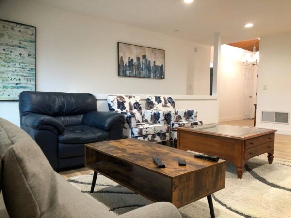 A living room with couches, tables and chairs.