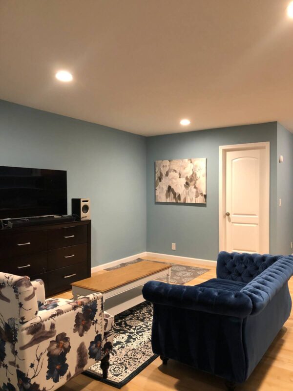 A living room with blue walls and furniture.