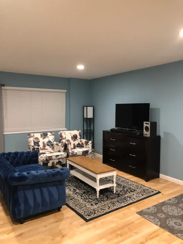 A living room with blue walls and furniture.