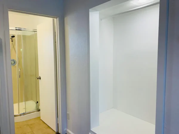 A bathroom with a shower and a toilet.