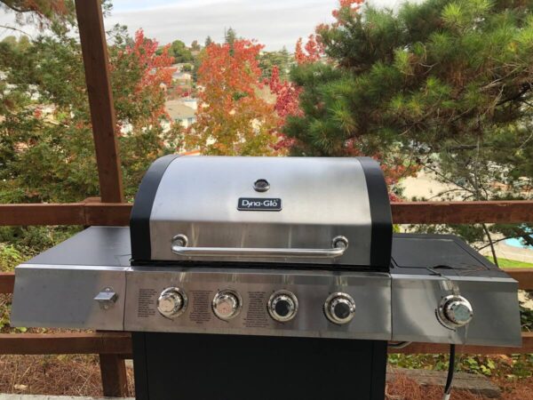 A grill with four burners and a side burner.