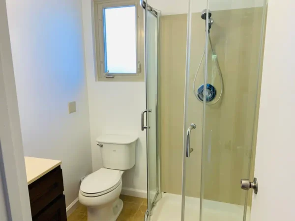 A bathroom with a toilet and shower in it