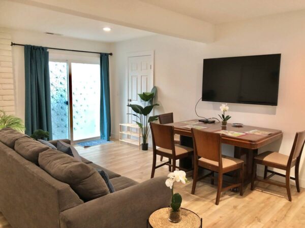 A living room with a couch, table and television.