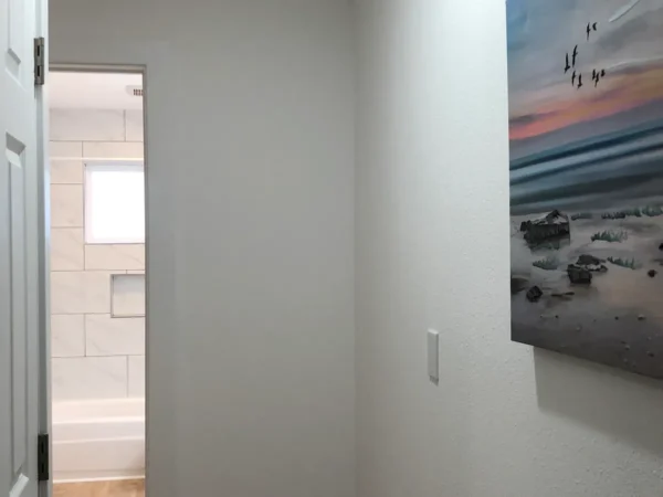 A painting of the ocean in a room.