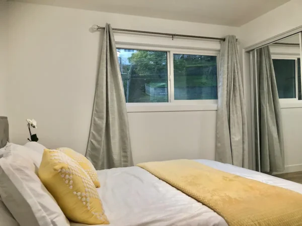 A bedroom with a bed and window in it