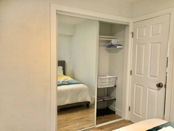 A bedroom with a bed and closet in it