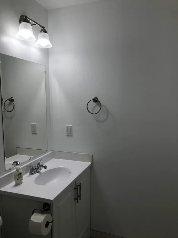 A bathroom with a sink and mirror in it