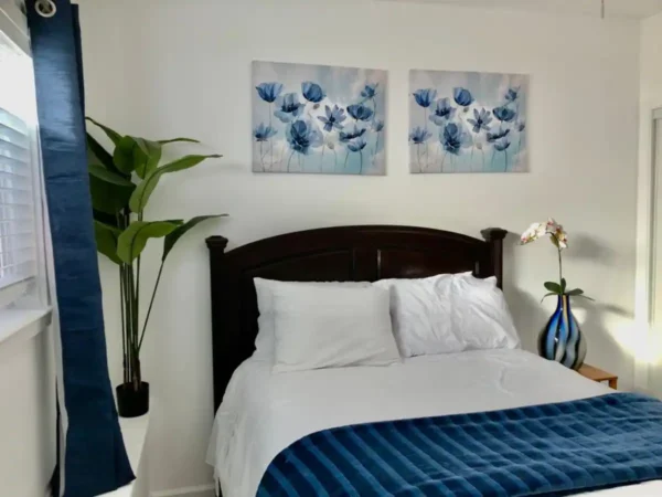 A bedroom with two pictures on the wall