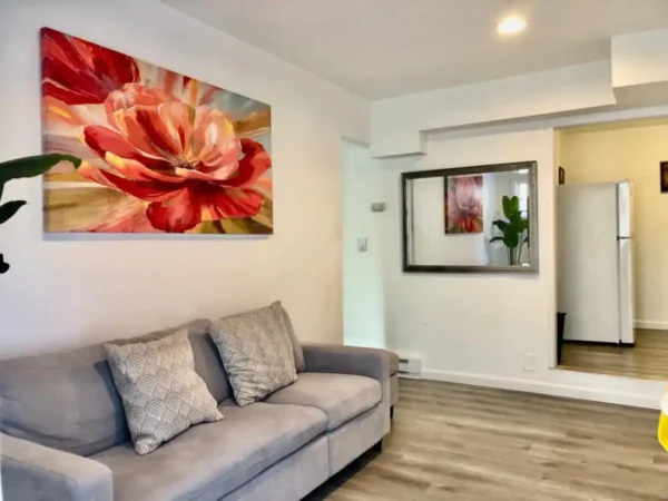 A living room with a couch and a mirror