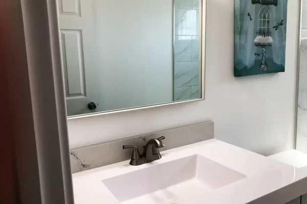 A bathroom with a sink and mirror in it