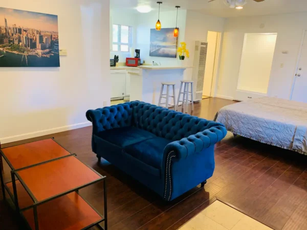 A blue couch in the middle of a room.