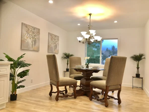 A dining room with four chairs and a table