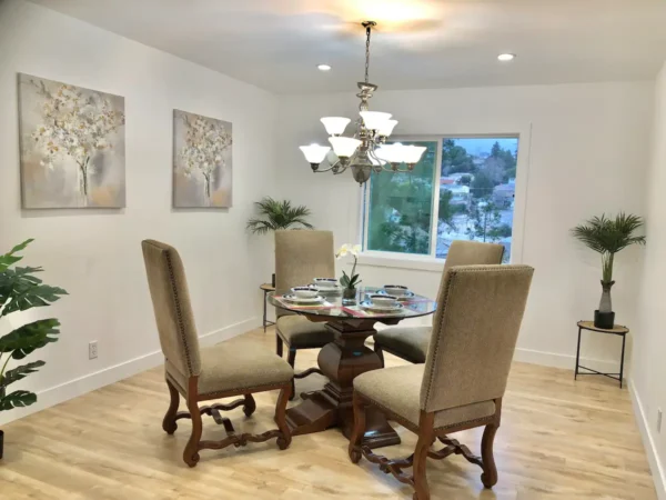 A dining room with four chairs and a table