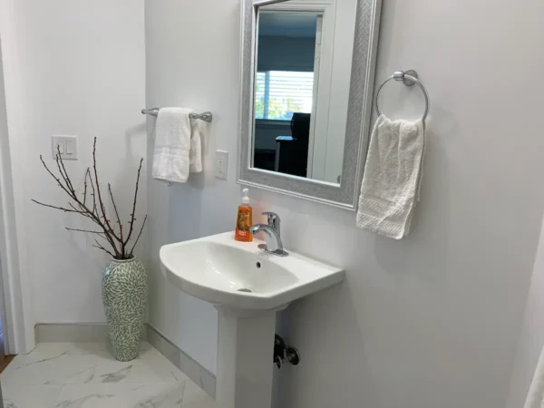 A bathroom with a sink and mirror in it