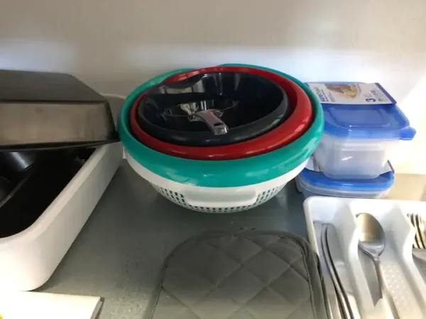 A kitchen counter with bowls and plates on it.