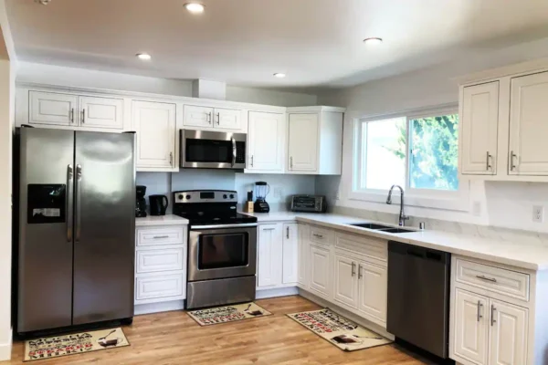 A kitchen with white cabinets and stainless steel appliances.