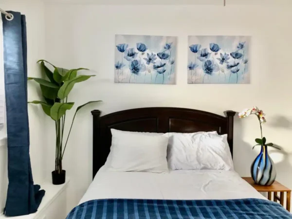 A bedroom with two pictures on the wall