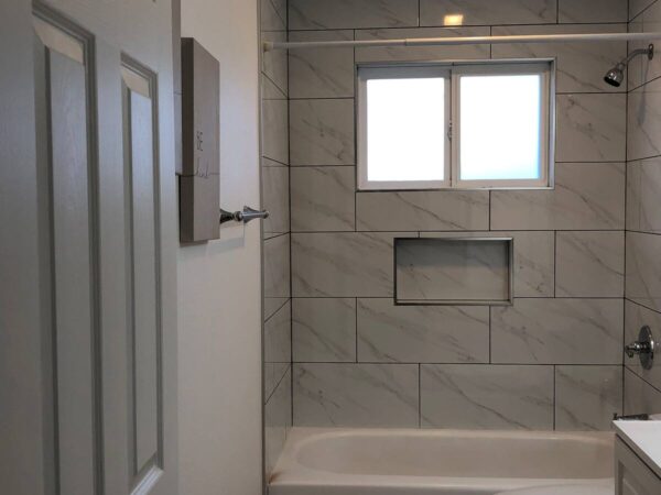 A bathroom with a window and a shower.