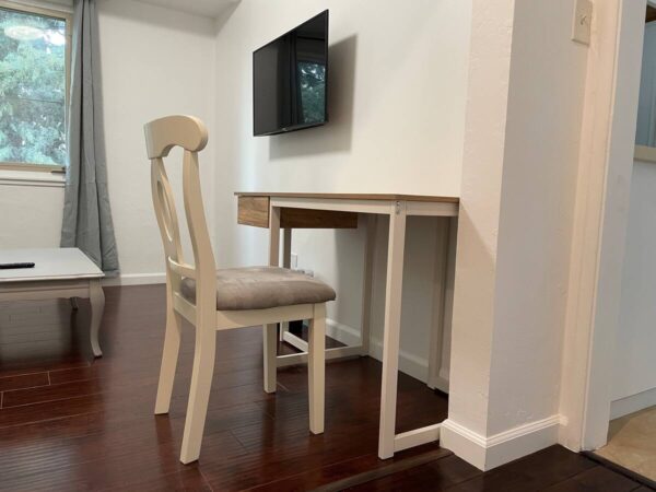 A chair and table in front of a television.