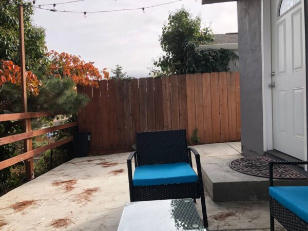 A blue chair and table in the middle of an outdoor patio.