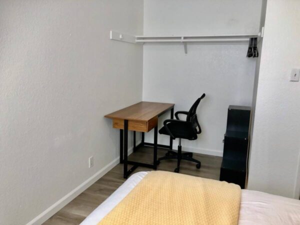 A room with a desk and chair in it