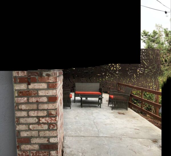 A brick wall with a bench and table in the middle of it.