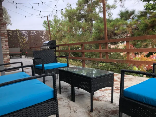 A patio with blue chairs and tables