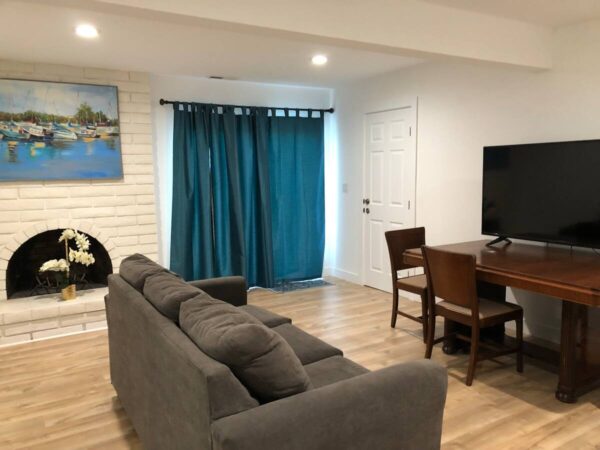 A living room with a couch, table and television.