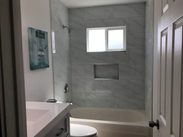 A bathroom with a toilet, sink and tub.