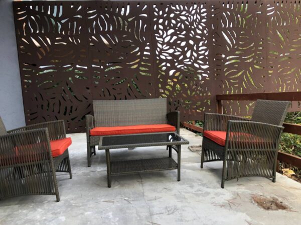 A patio set with red cushions and a table.