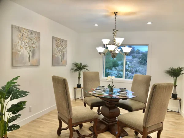 A dining room with four chairs and a table