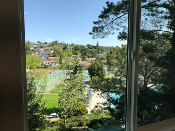 A view of a tennis court from the window.