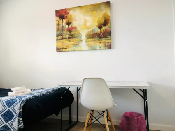 A white chair and table in a room.