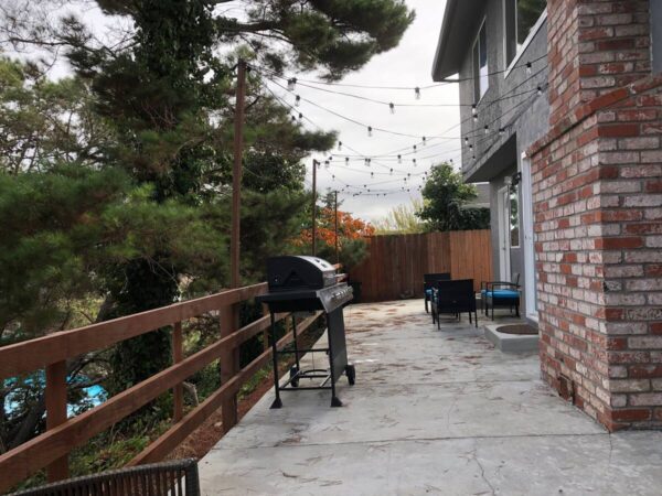 A bbq grill sitting on top of a brick patio.