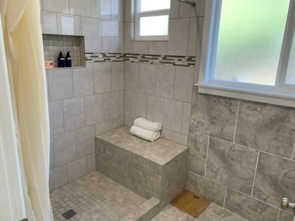 A bathroom with tiled walls and floors