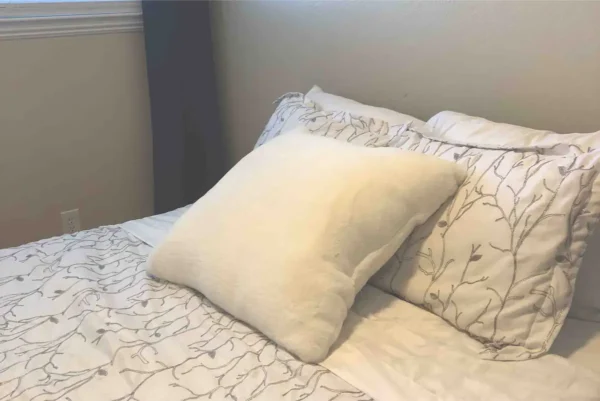 A bed with pillows and blankets on it