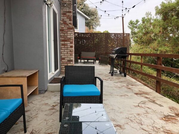 A patio with a blue chair and table