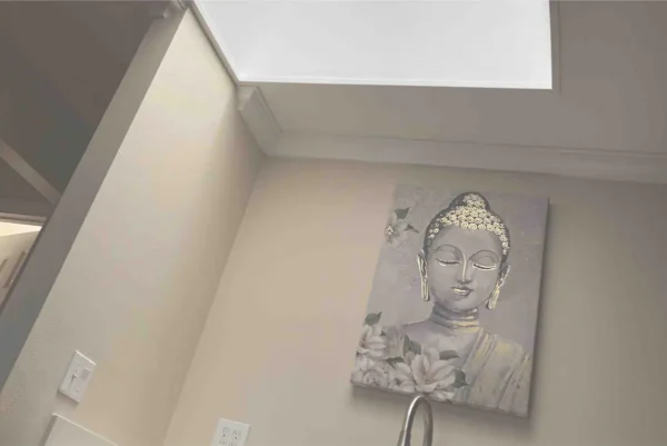 A picture of a buddha on the wall.