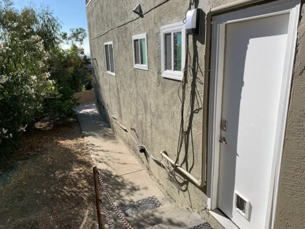 A house with an electrical box on the side of it.