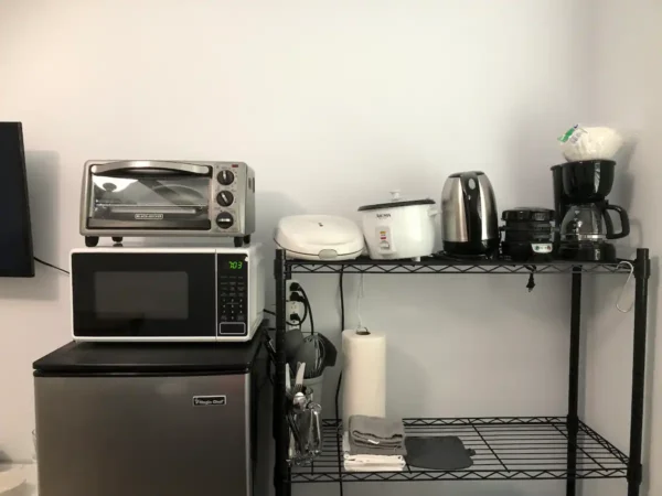 A kitchen with a microwave and toaster oven.