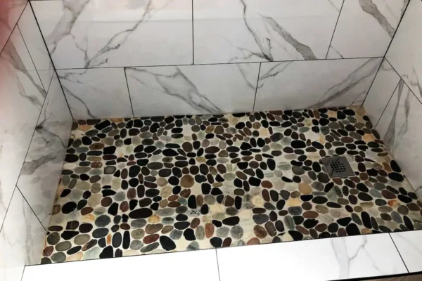 A bathroom with a shower and tiled floor