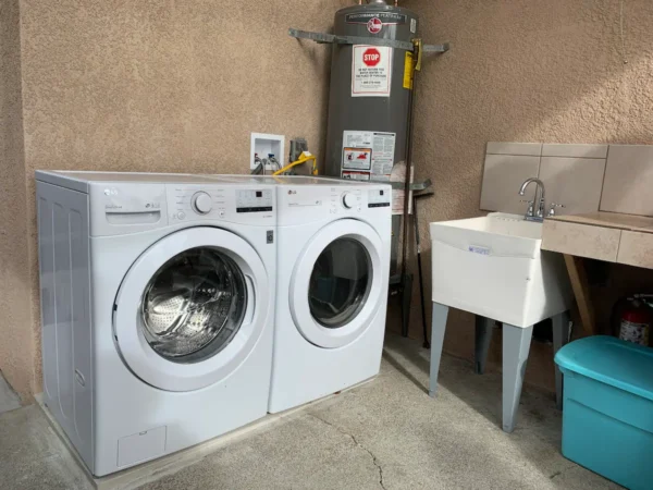 A washer and dryer in the middle of a room.