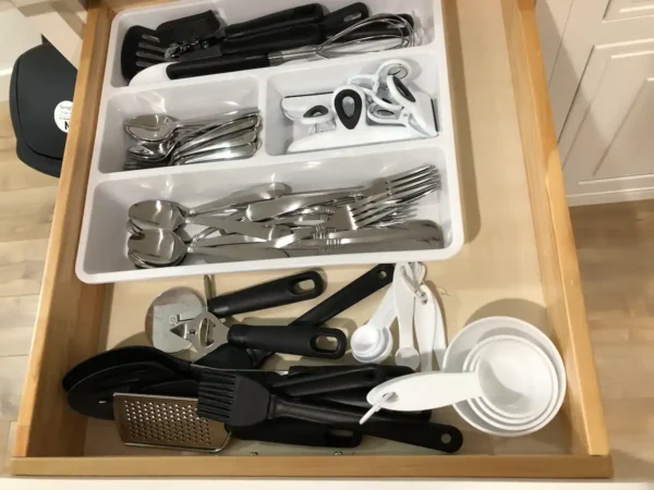 A drawer with many different utensils in it