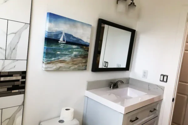 A bathroom with a sink and mirror in it