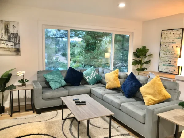 A living room with couches and pillows on the couch