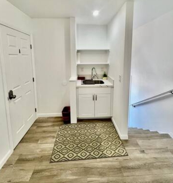 A kitchen with a sink and a door way