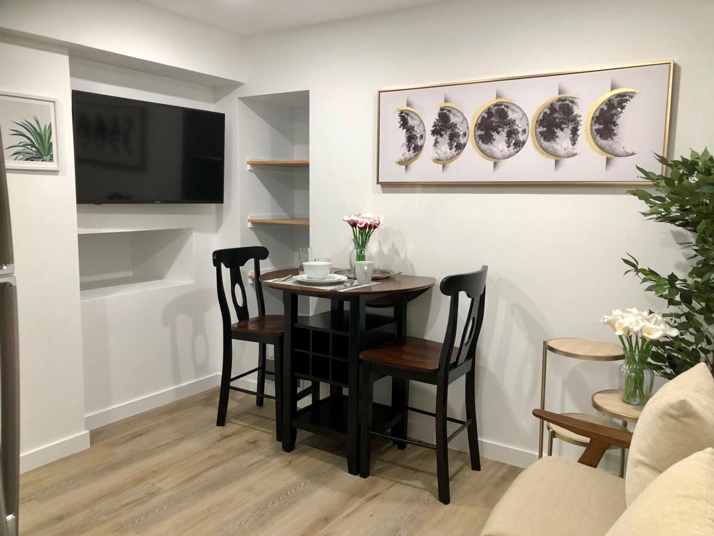 A small table and chairs in the corner of a room.